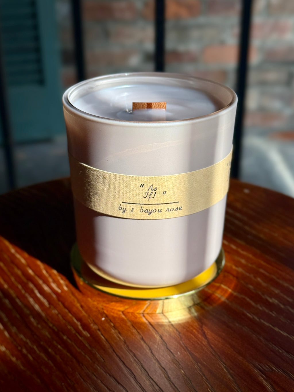Bayou Rose As If! Candle with typewritten label on warm wood — orange blossom and freesia scented