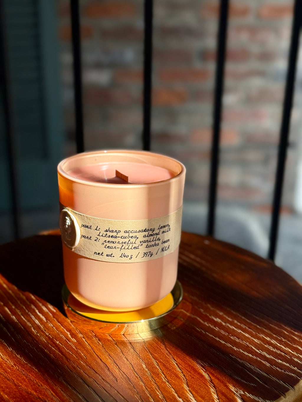 Badly Done Emma candle scent notes label — sharp citrus, litsea cubeba, honey, coumarin, vanilla, white musk