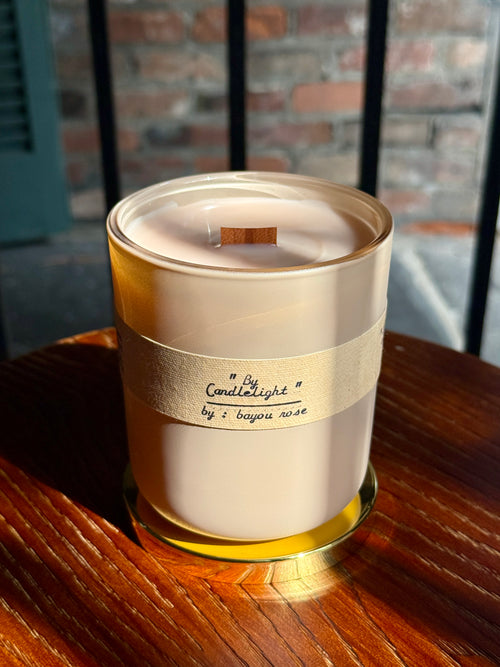 Bayou Rose By Candlelight candle — Northanger Abbey inspired beeswax, frankincense, and leather gothic novel candle on wood surface